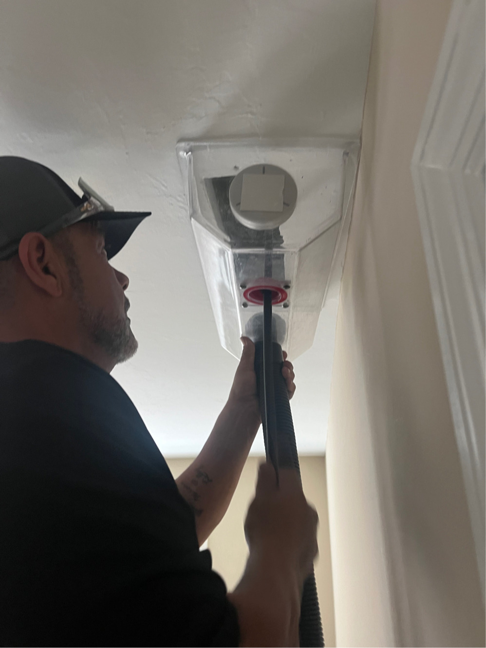 HomePros technician performing duct cleaning service at a ceiling register in Fort Myers