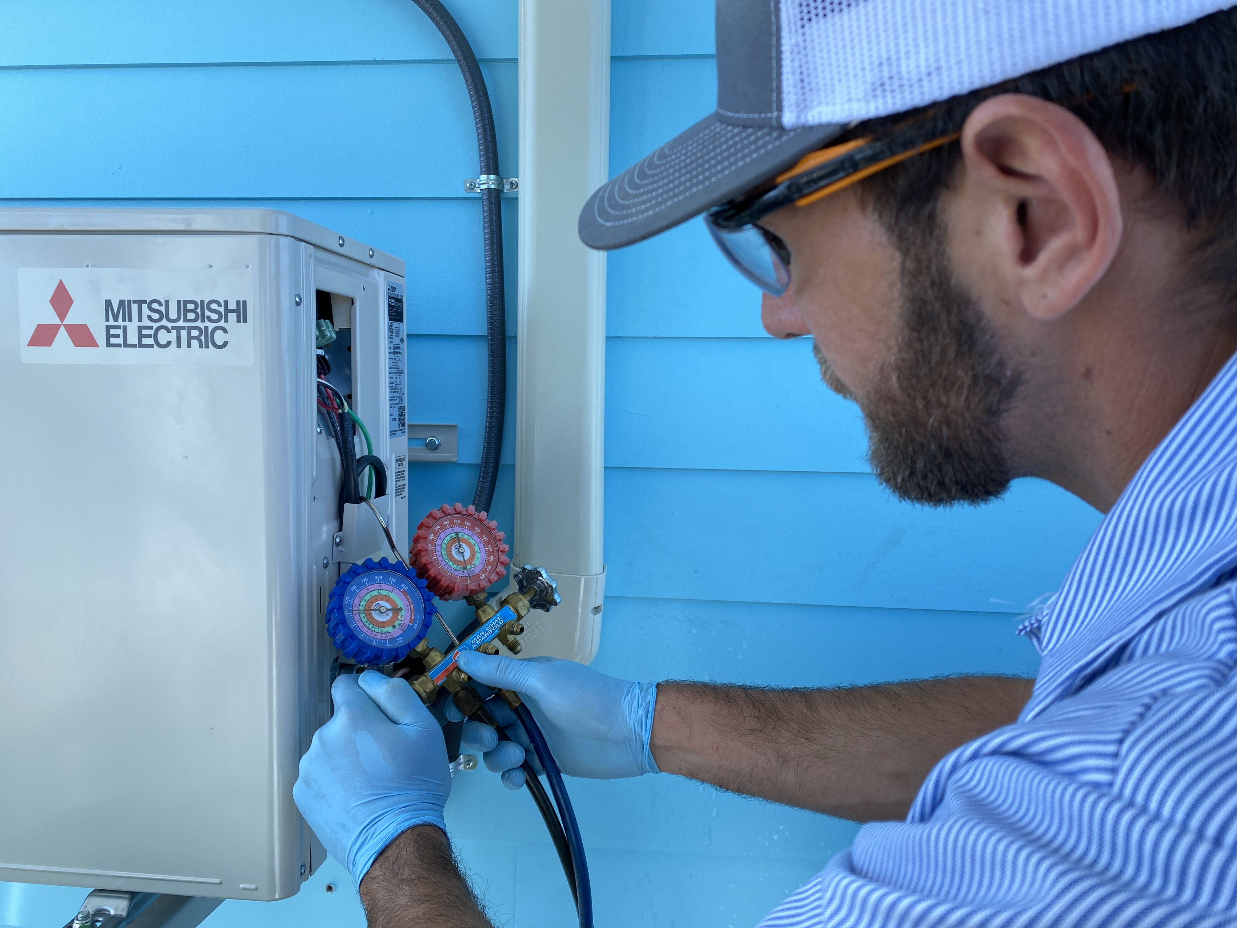 HomePros certified technician servicing an AC unit in Southwest Florida
