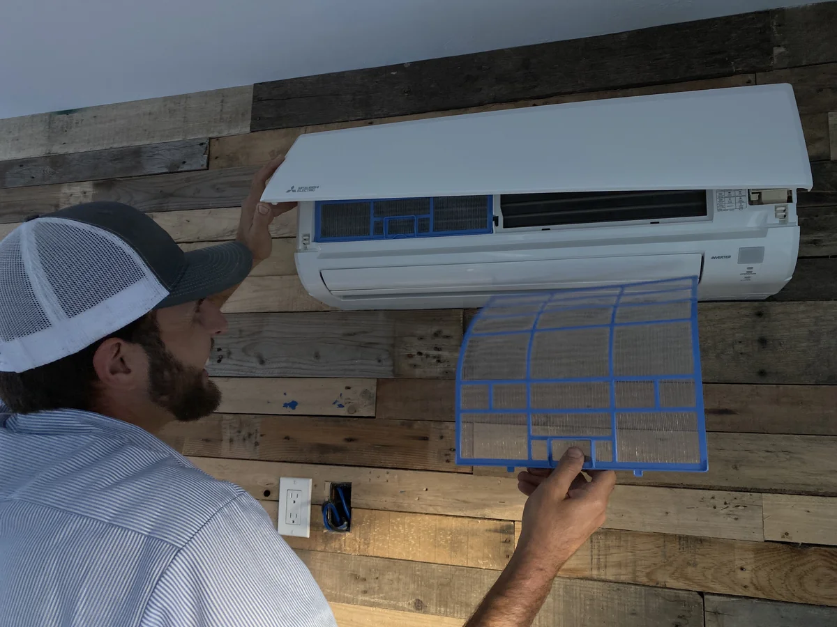 HomePros Cooling & Heating technician servicing a ductless mini-split in Cape Coral